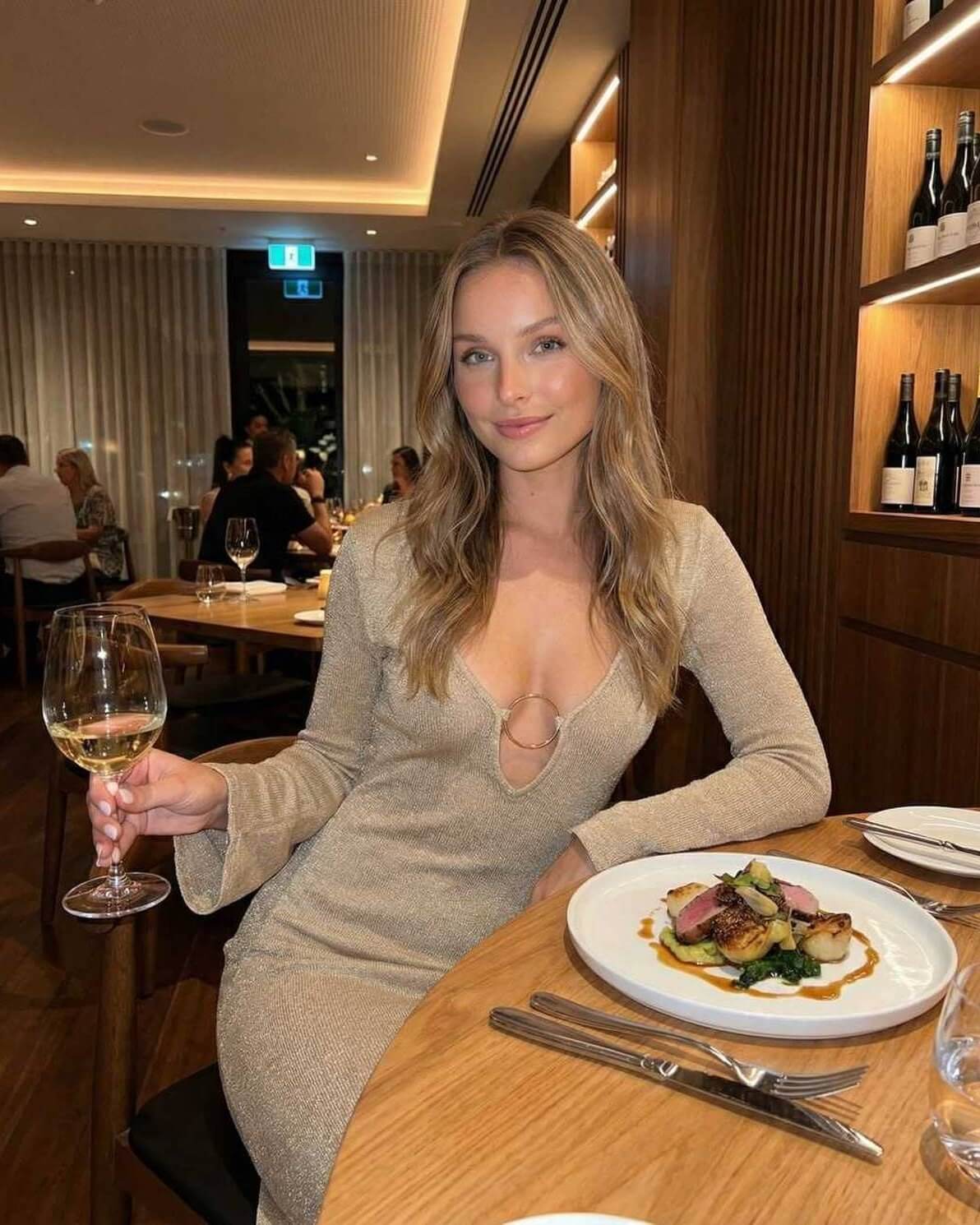 Solea Maxi Dress by Lauven, long sleeve deep V-neck bodycon dress worn at a stylish dinner, elegant atmosphere.