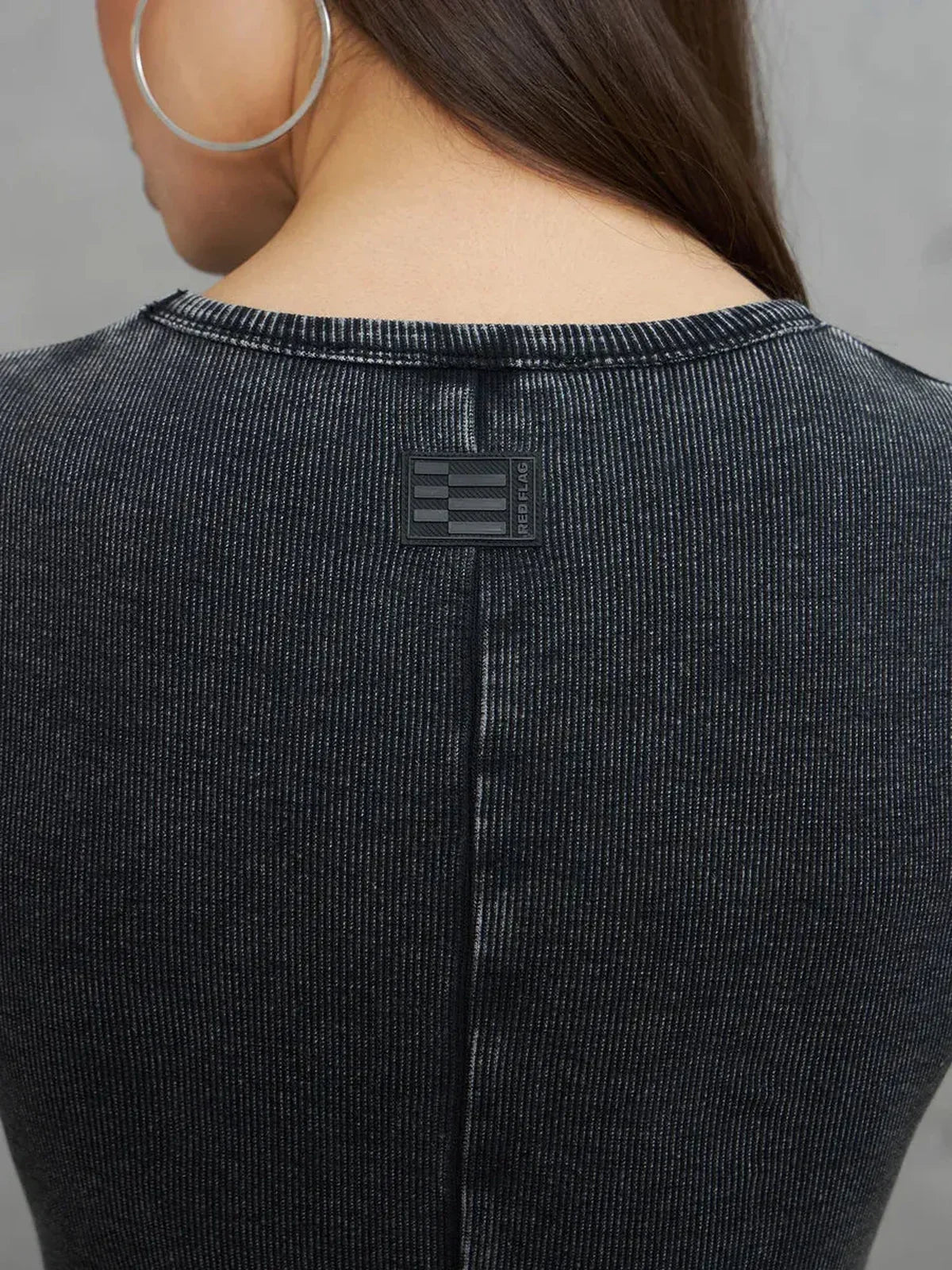 Back view of the Graphite Form Maxi Dress showcasing minimalist design and detailing.