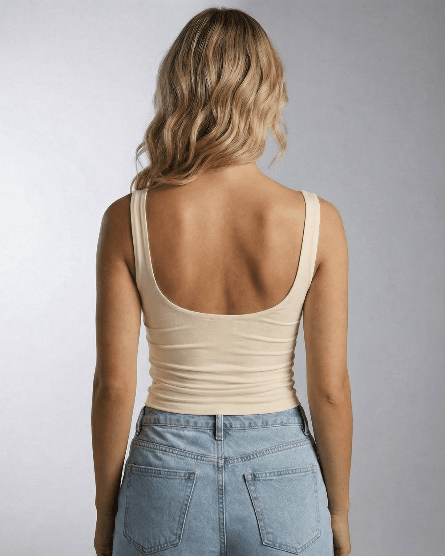 Back view of a model wearing the Aurelia Top by Lauven, showcasing its clean square neckline and sleek design.