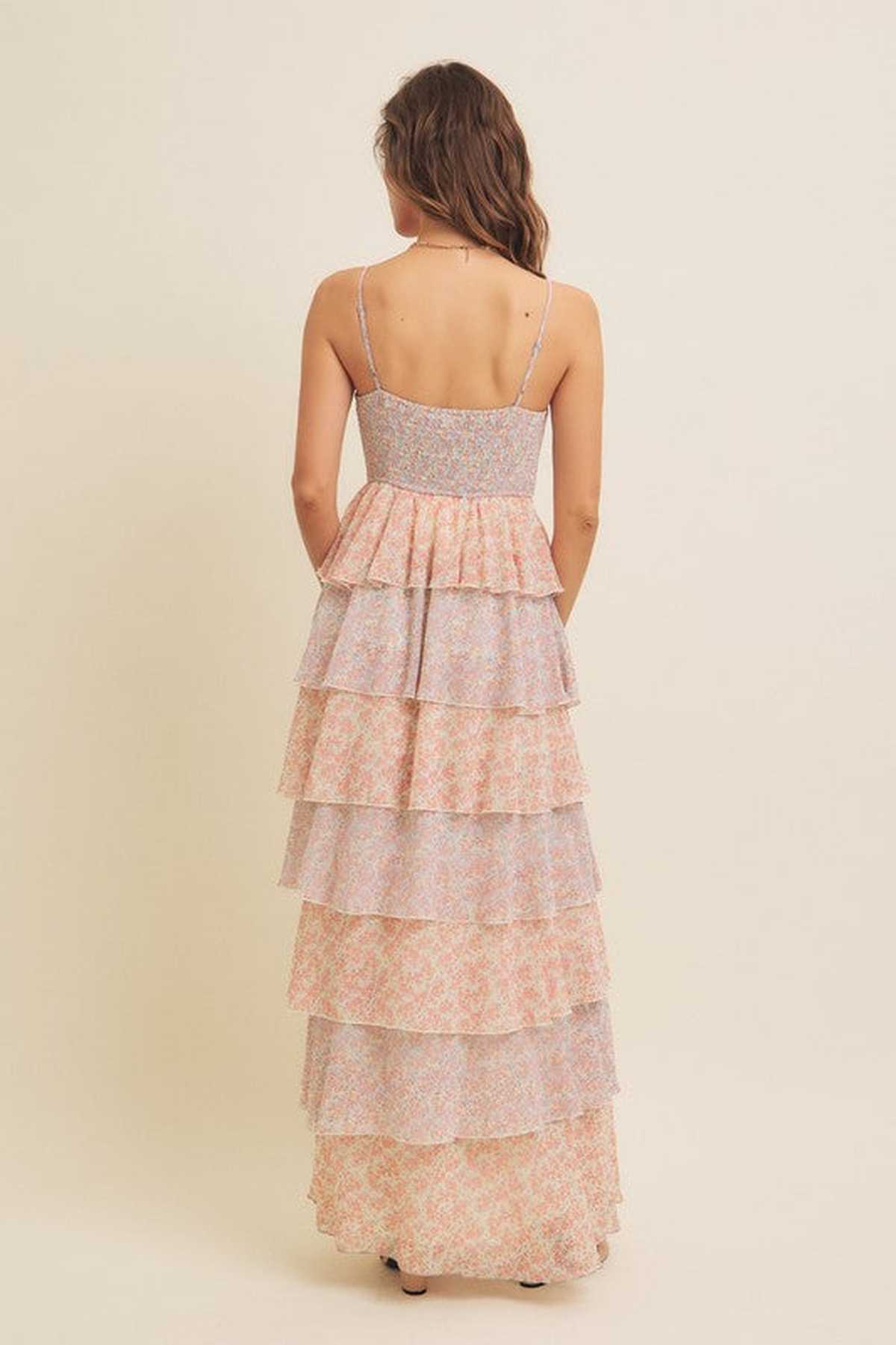 Back view of the Aurora Women's Dress featuring cascading tiered layers in pastel floral print, perfect for summer occasions.