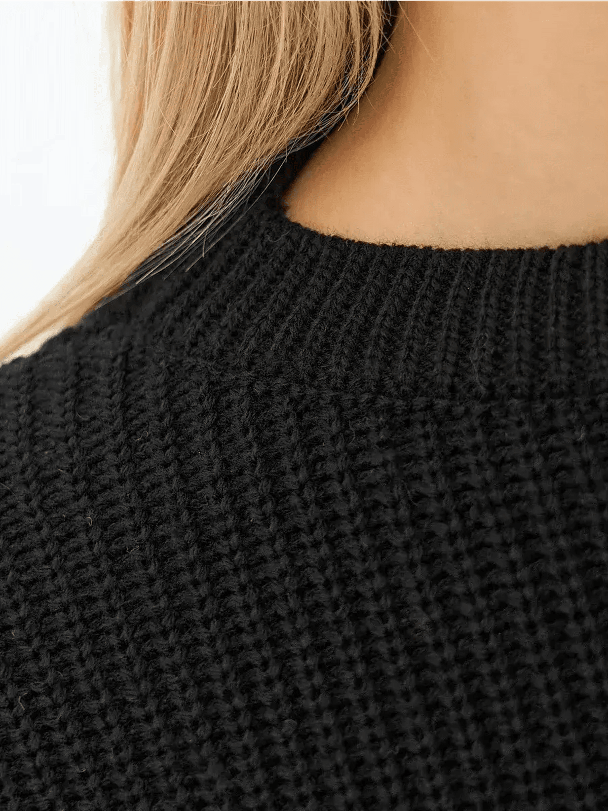 Close-up of the Eclipse Sweater by Lauven, showcasing the textured knit in classic black.