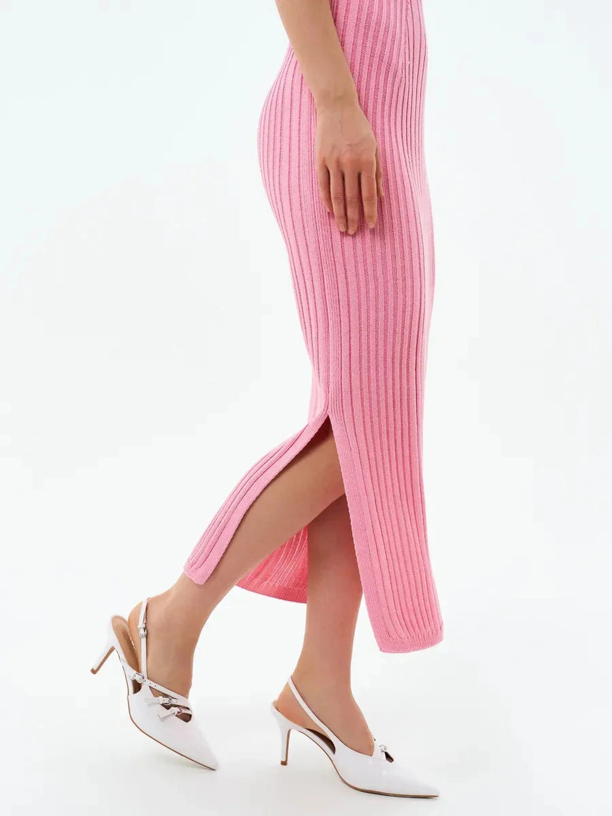 Rosalie Midi Dress by Lauven, showcasing a side view of the soft pink ribbed knit fabric and subtle side slit.
