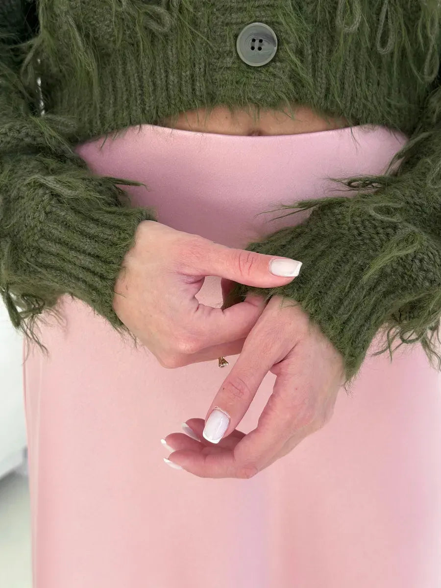 Olive Cardigan by Lauven featuring cozy cropped design and feathered fringe details, hands showing the textured knit sleeves.