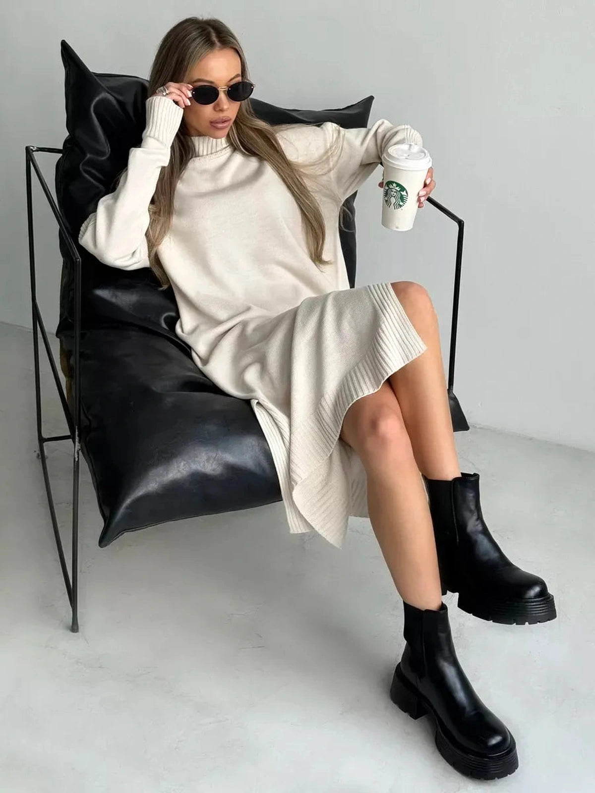 Celeste Midi Dress by Lauven displayed on a model wearing sunglasses, relaxed in a chair with a coffee.