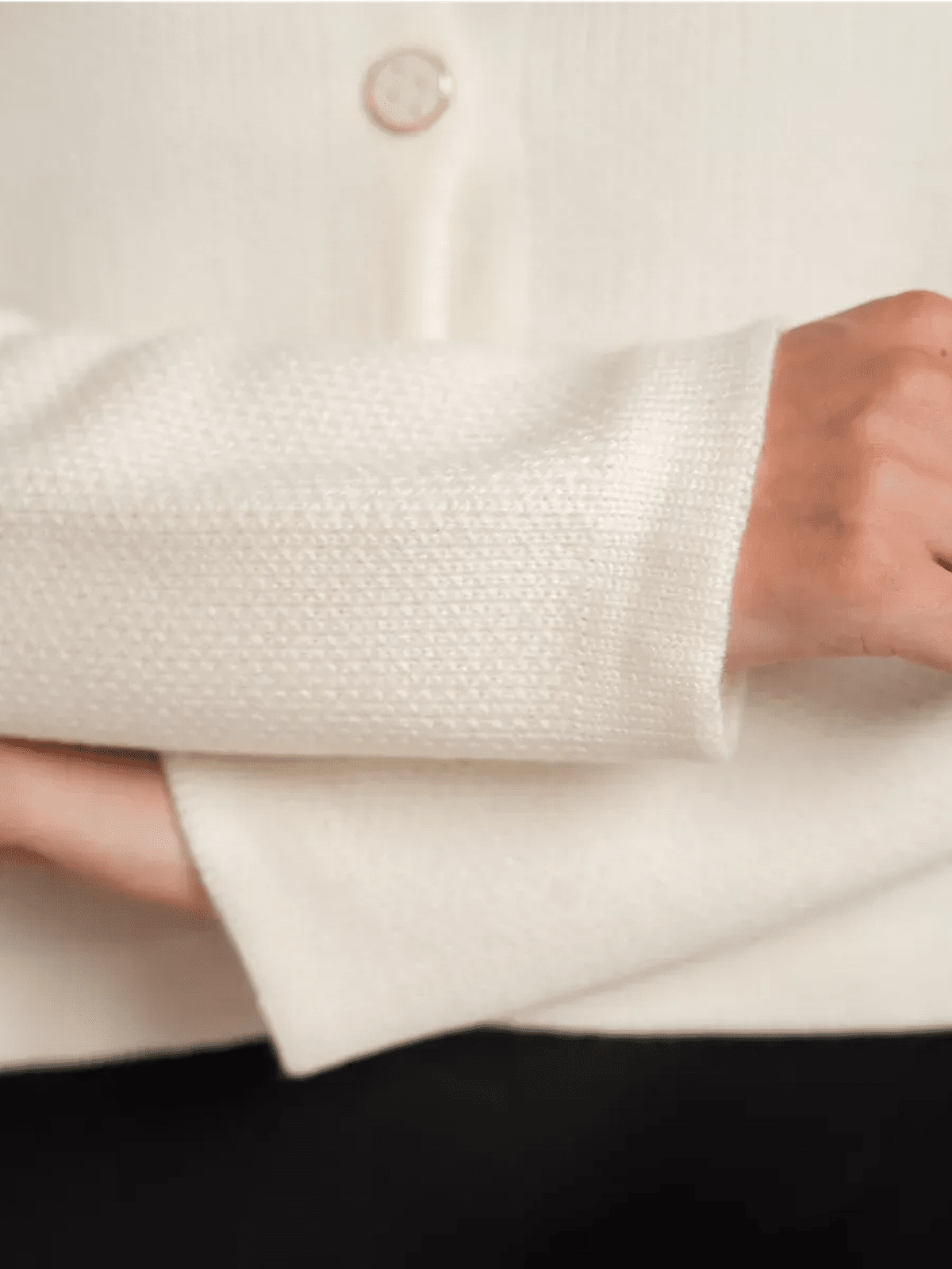 Ivory Cardigan by Lauven featuring a close-up of the creamy white knit and decorative button detail.