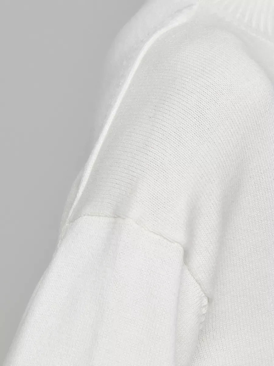 Close-up of the sleeve detailing on the Bianca Sweater by Lauven, an oversized cotton blend knit in white.