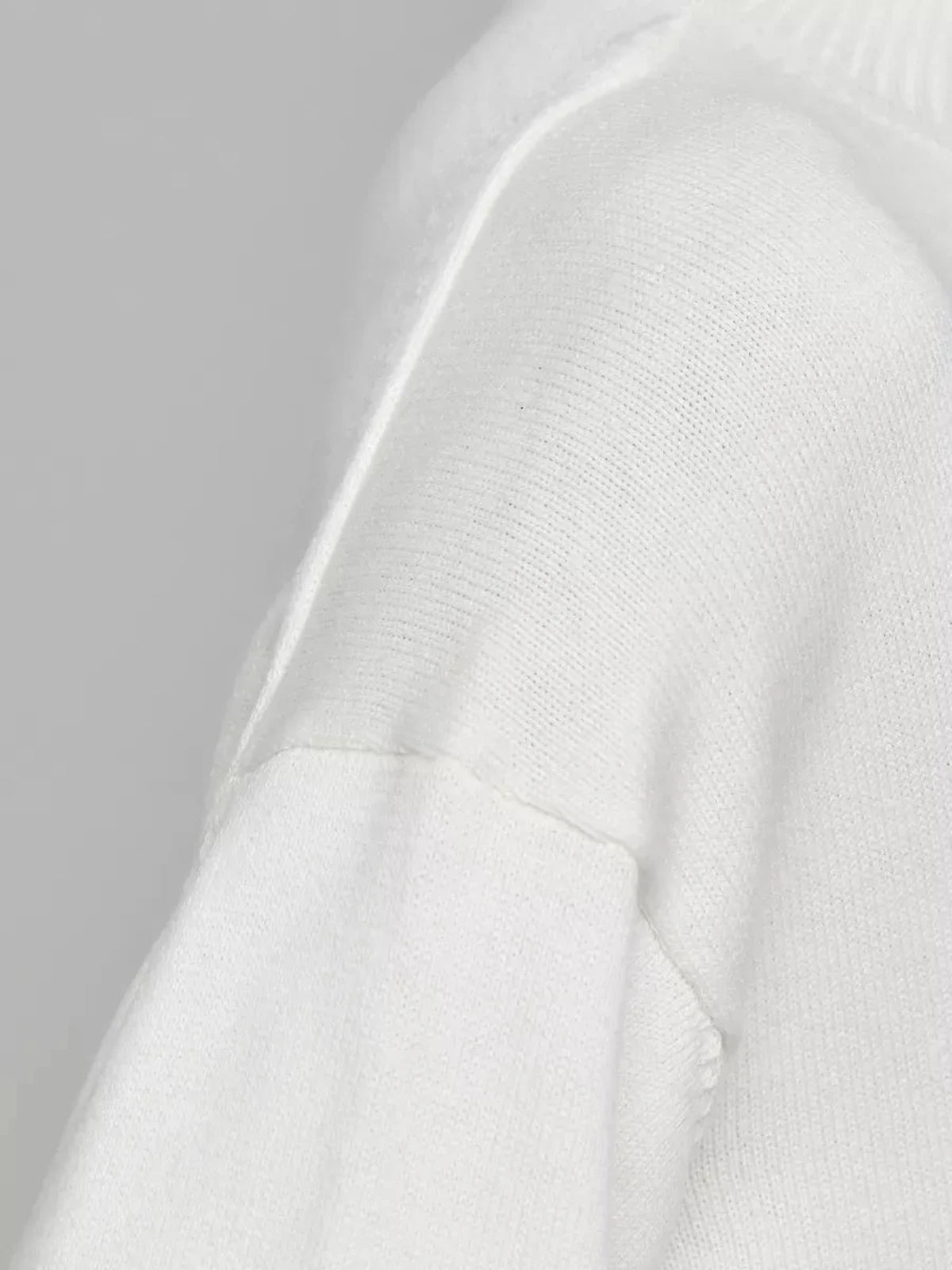 Close-up of the sleeve detailing on the Bianca Sweater by Lauven, an oversized cotton blend knit in white.