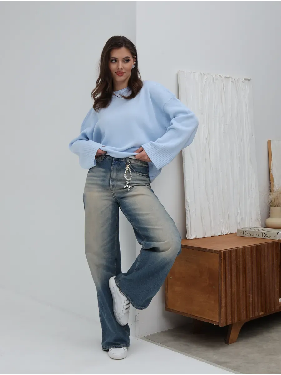 Celine Sweater by Lauven, oversized knit in sky blue, styled with light blue jeans, showcasing casual elegance.