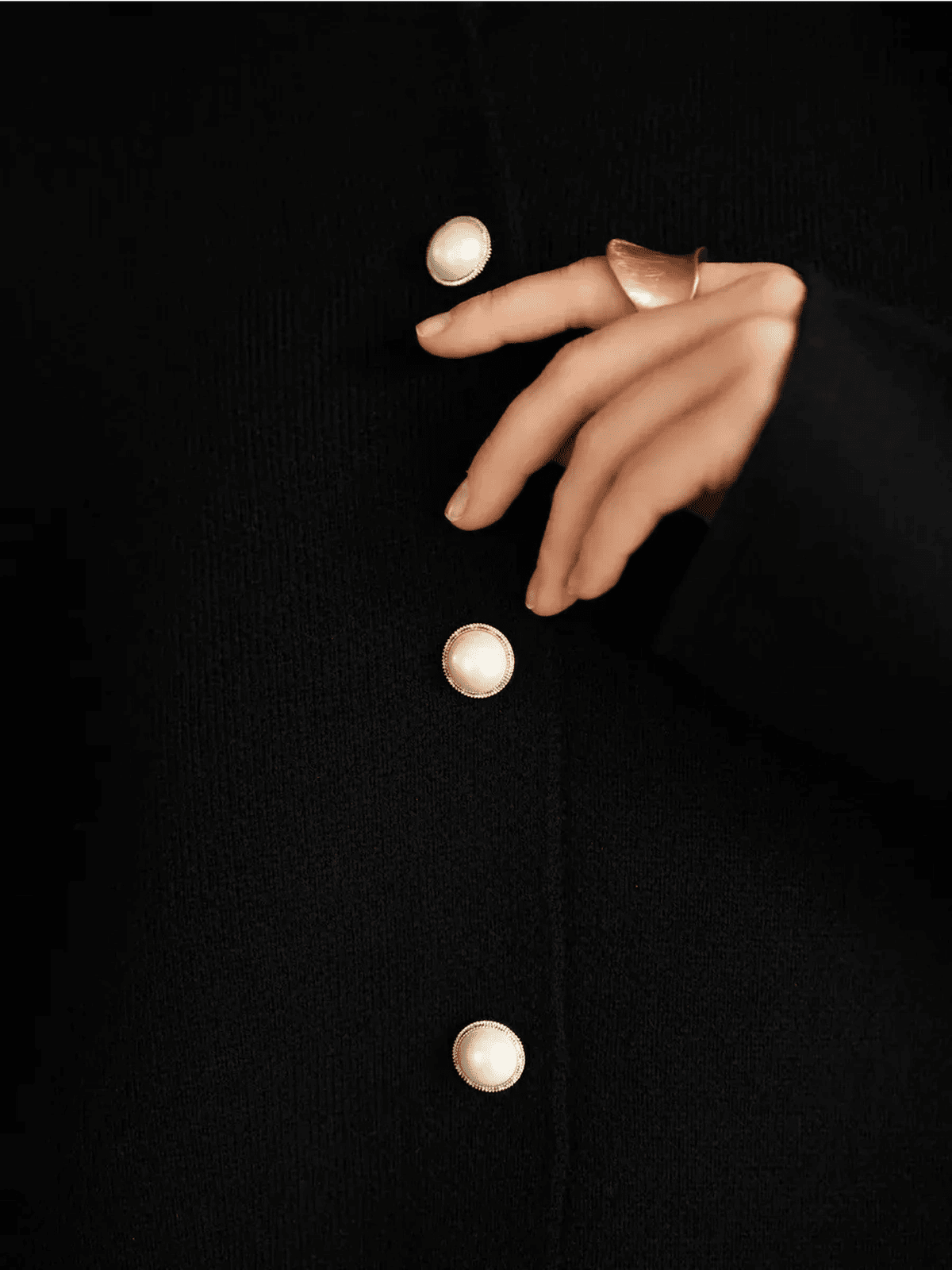 Noir Cardigan by Lauven featuring classic black knit and elegant pearl button closure.