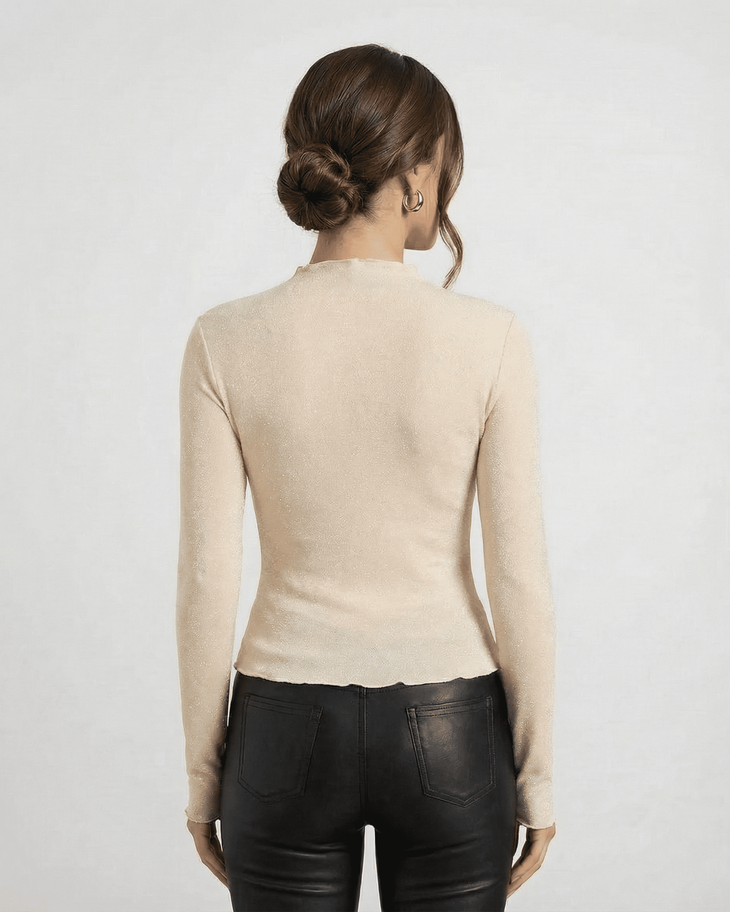 Back view of a woman wearing the Alba Blouse by Lauven, showcasing its long sleeves and sleek fit.