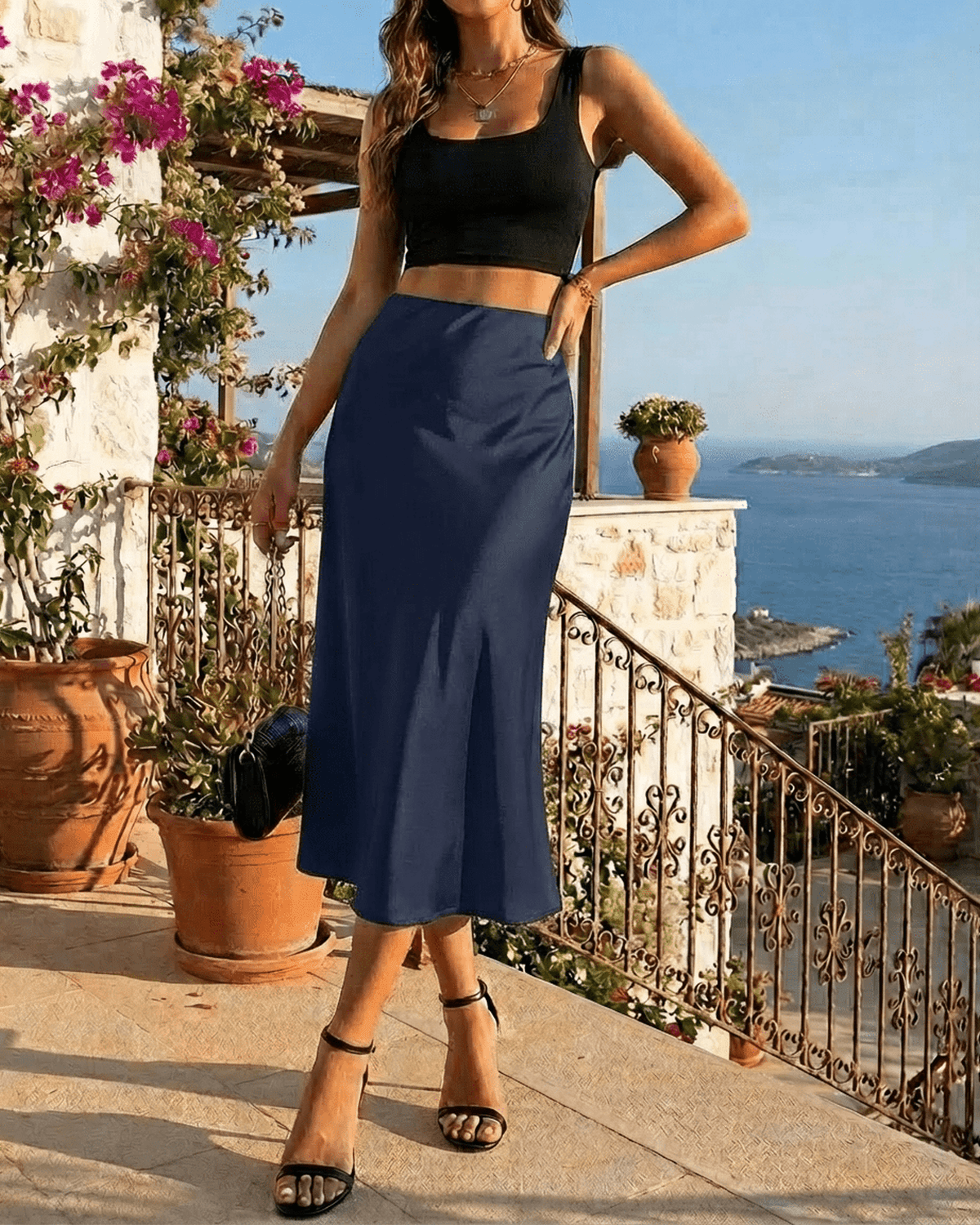 Astra Midi Skirt by Lauven, a satin mermaid midi skirt in deep navy, showcasing elegance by the seaside.