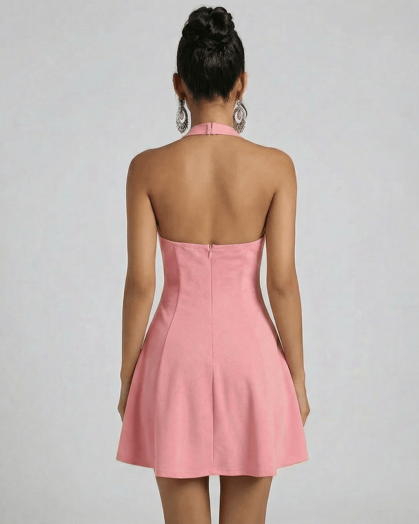 Back view of the Lauven Aurora Mini Dress featuring a flared silhouette and U-neck halter design in solid pink.
