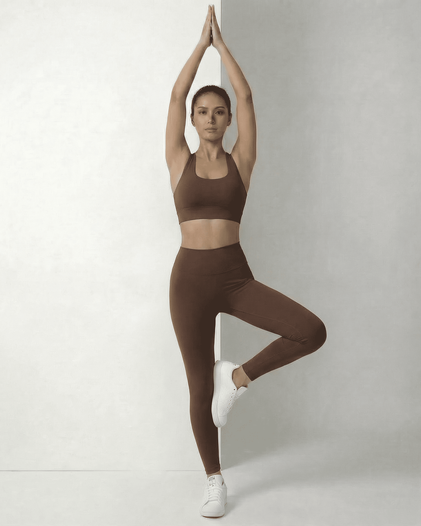 Woman practicing yoga in sleek Hazel Leggings and matching top by Lauven, showcasing comfort and style.