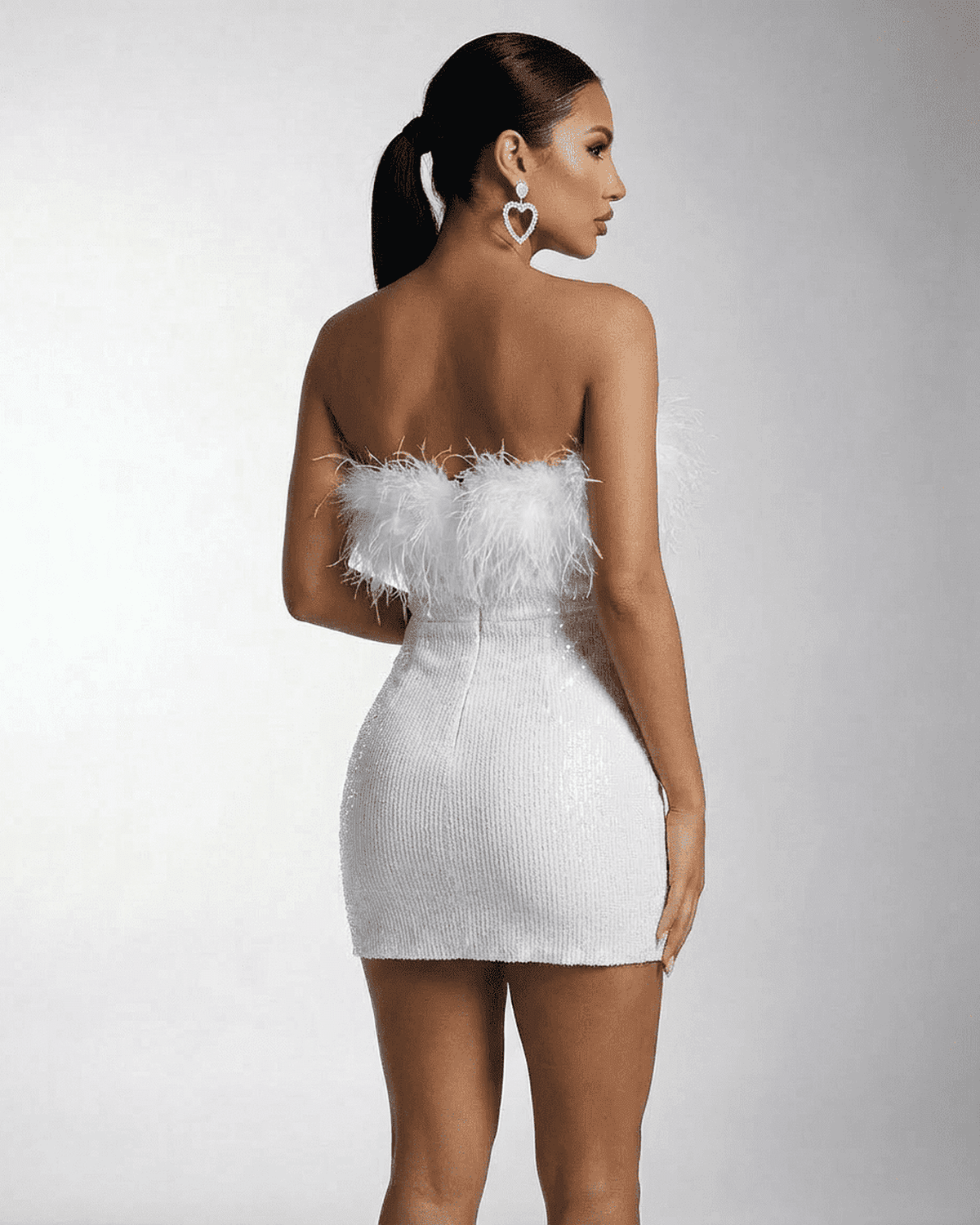 Luna Mini Dress by Lauven, a strapless white dress with sequins and feather fringe detail.