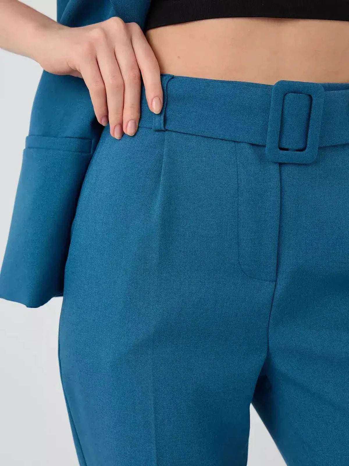 Marine Suit Set by Lauven – close-up of teal high-waist pants with stylish buckle detail.