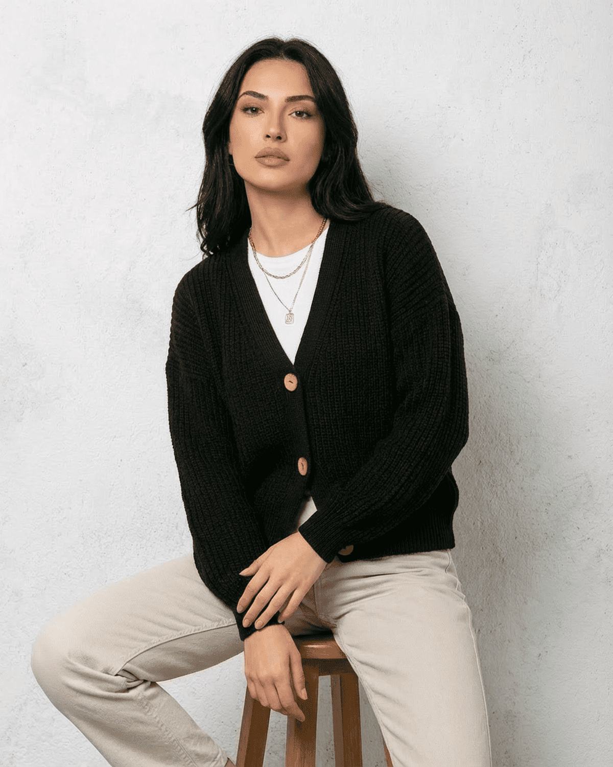 Noir Cardigan by Lauven, a sleek black knitwear piece with classic V-neck and button detail.