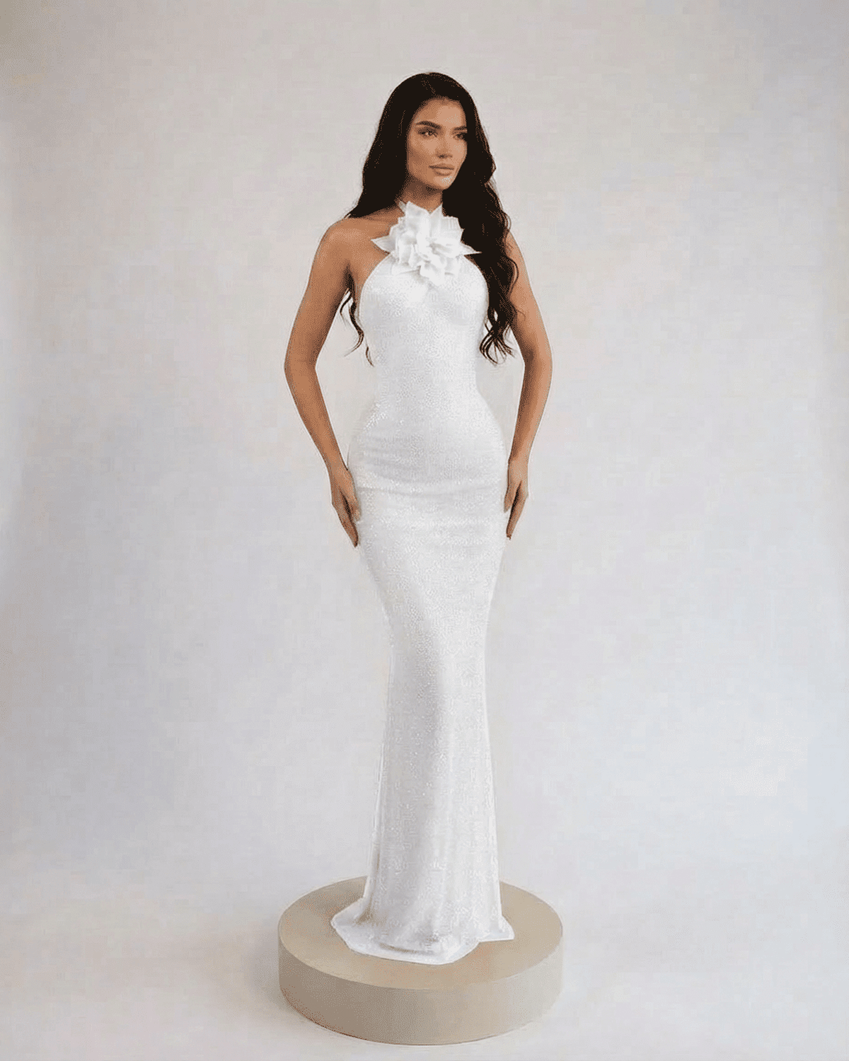 Lauven Pearl Maxi Dress featuring a halter neck and floral accent, showcasing an elegant floor-length silhouette.