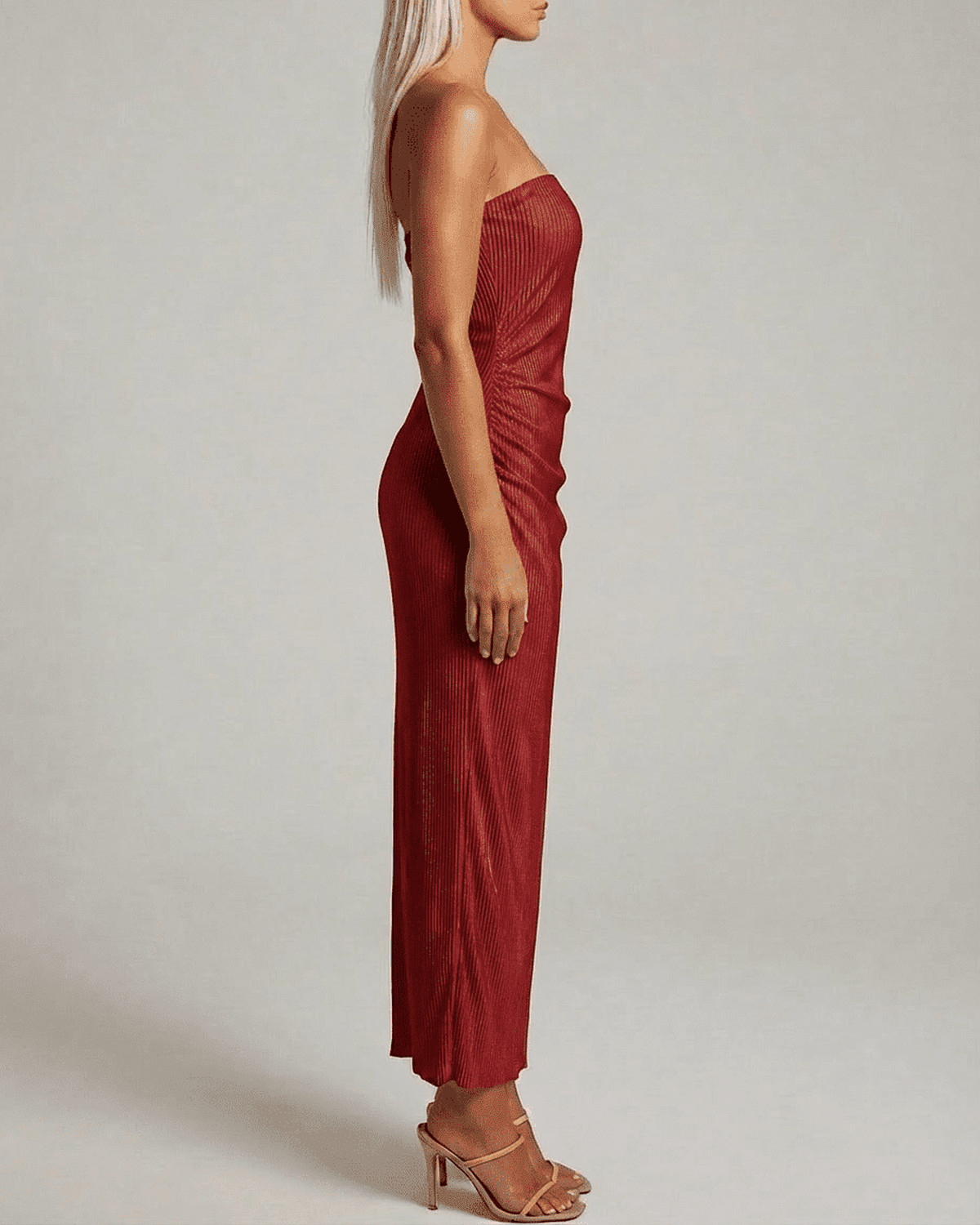 Side view of a woman wearing a Ruby Maxi Dress by Lauven, featuring a strapless tube silhouette and subtle ruched texture.