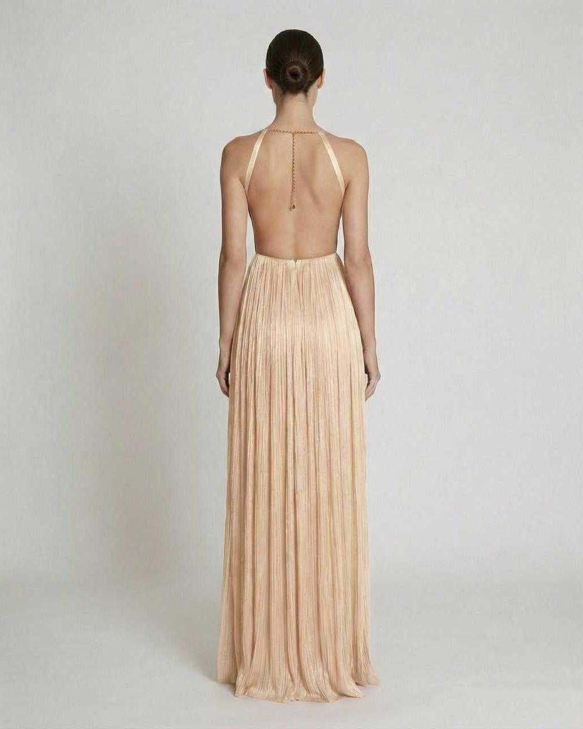 Back view of the Sable Maxi Dress by Lauven, featuring a pleated design and halter neckline in elegant beige.