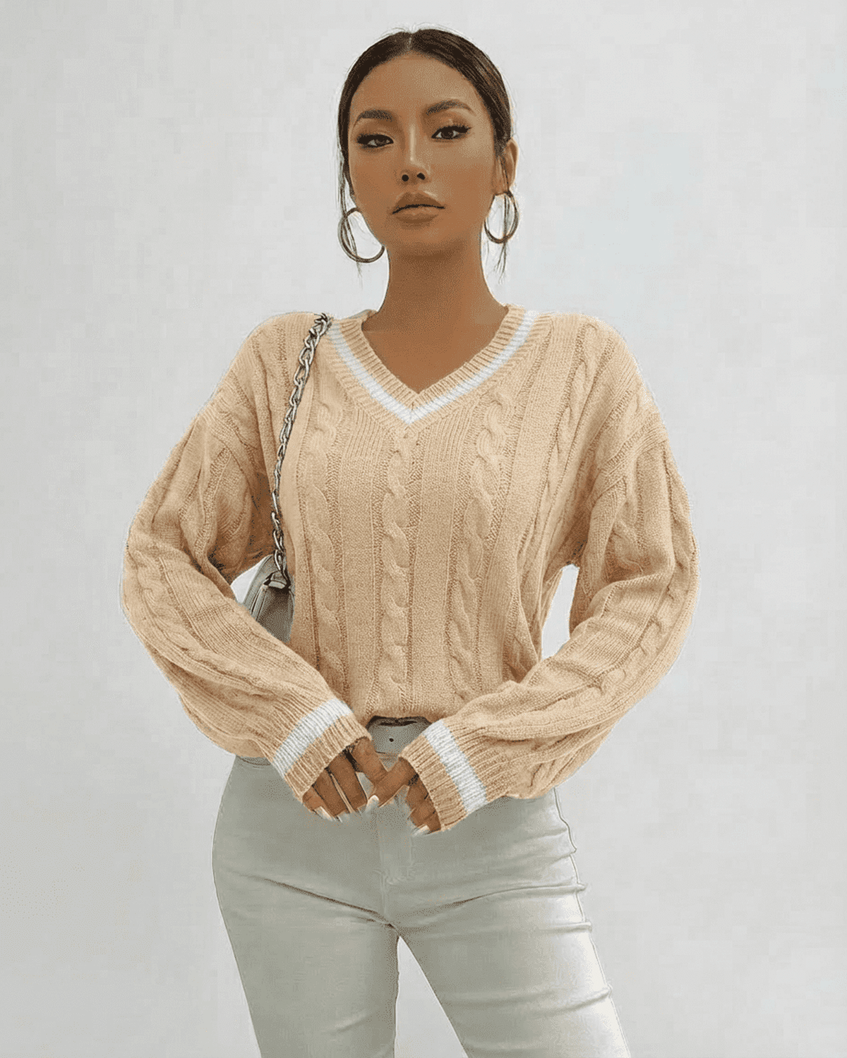 Model wearing Lauven Savona Sweater, a cable knit V-neck pullover, showcasing elegance and comfort.