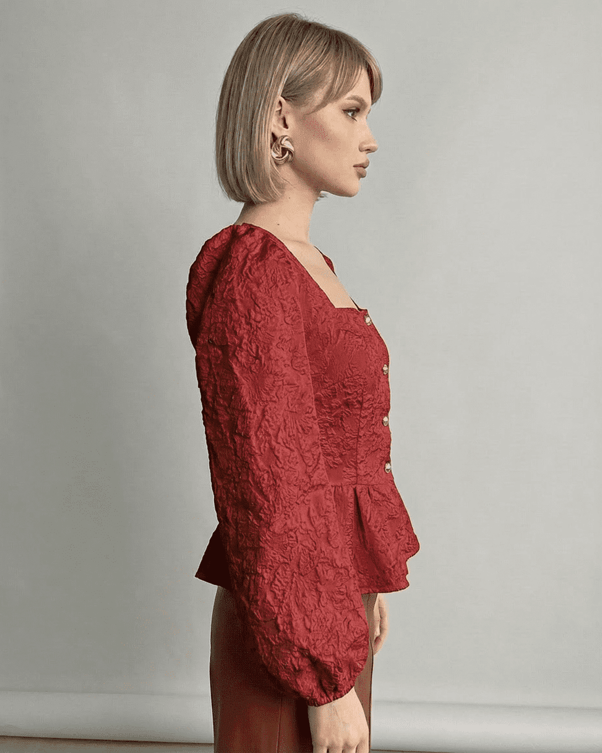 Scarlet Corset Top by Lauven featuring jacquard texture and structured puff sleeves in a deep red hue.