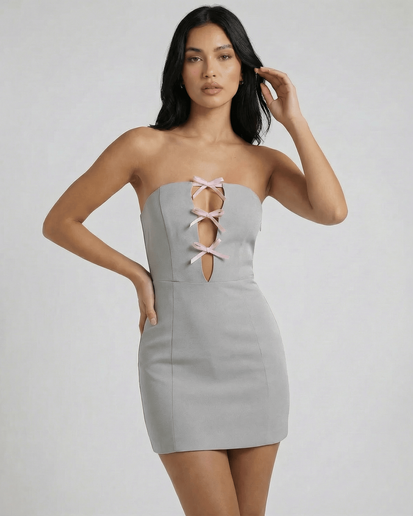 Selene Mini Dress by Lauven, featuring a strapless design with bow accents and a hollow-out detail in a sleek gray silhouette.
