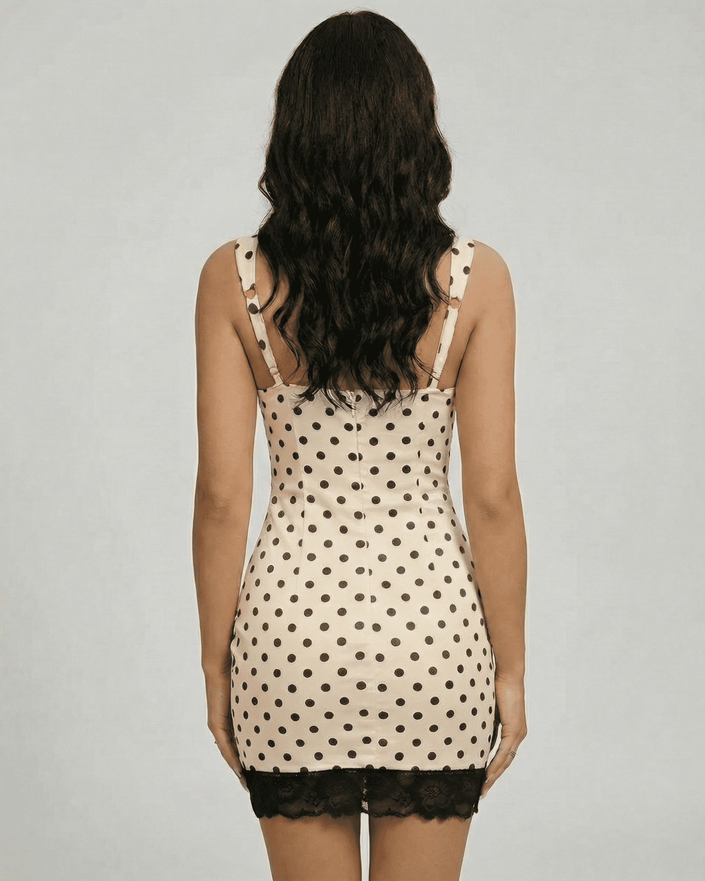 Valencia Mini Dress by Lauven, showcasing polka dot design and lace trim from the back view.
