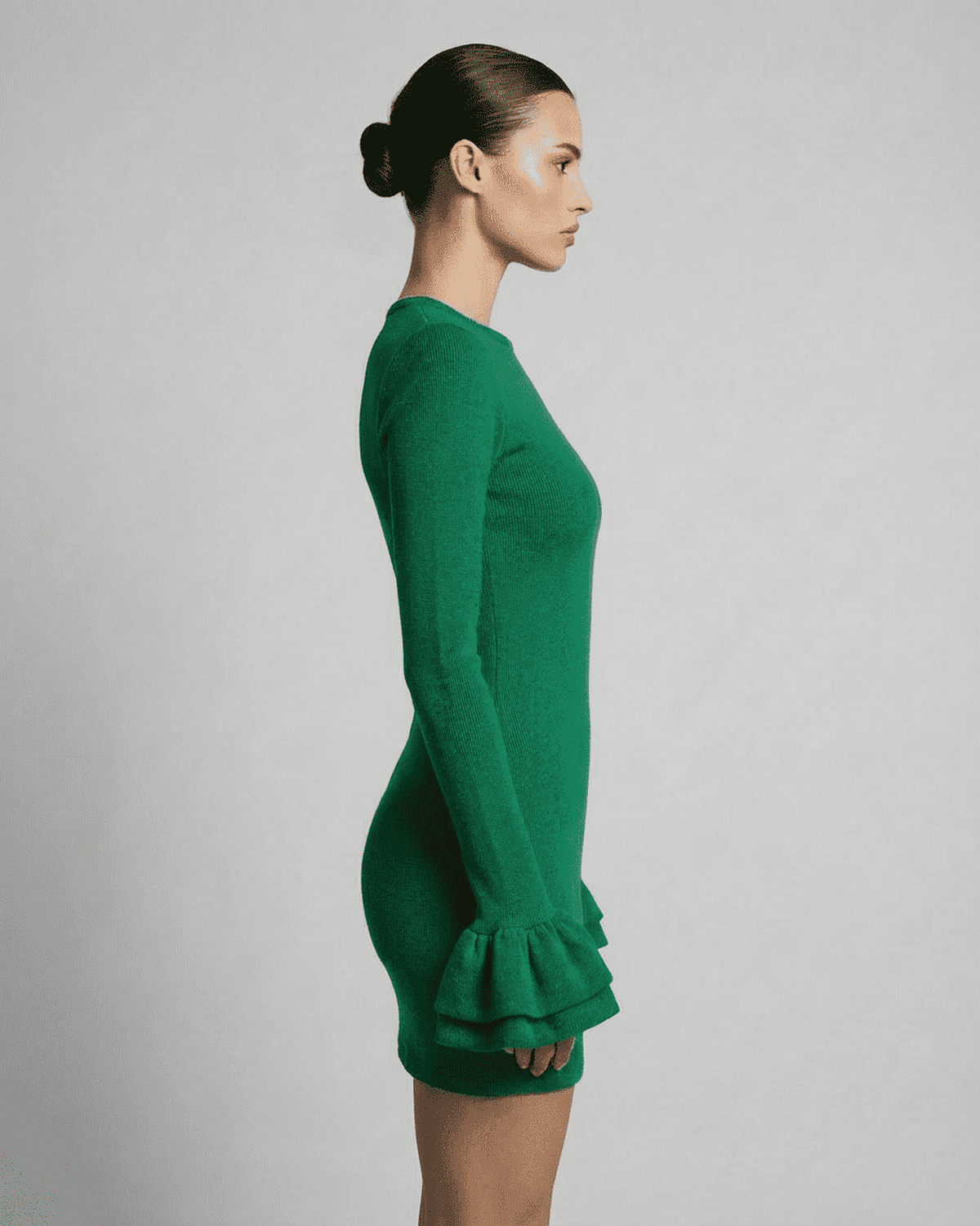 Lauven Verdant Mini Dress showcased side view, featuring ruffled sleeves and a fitted silhouette in rich green.