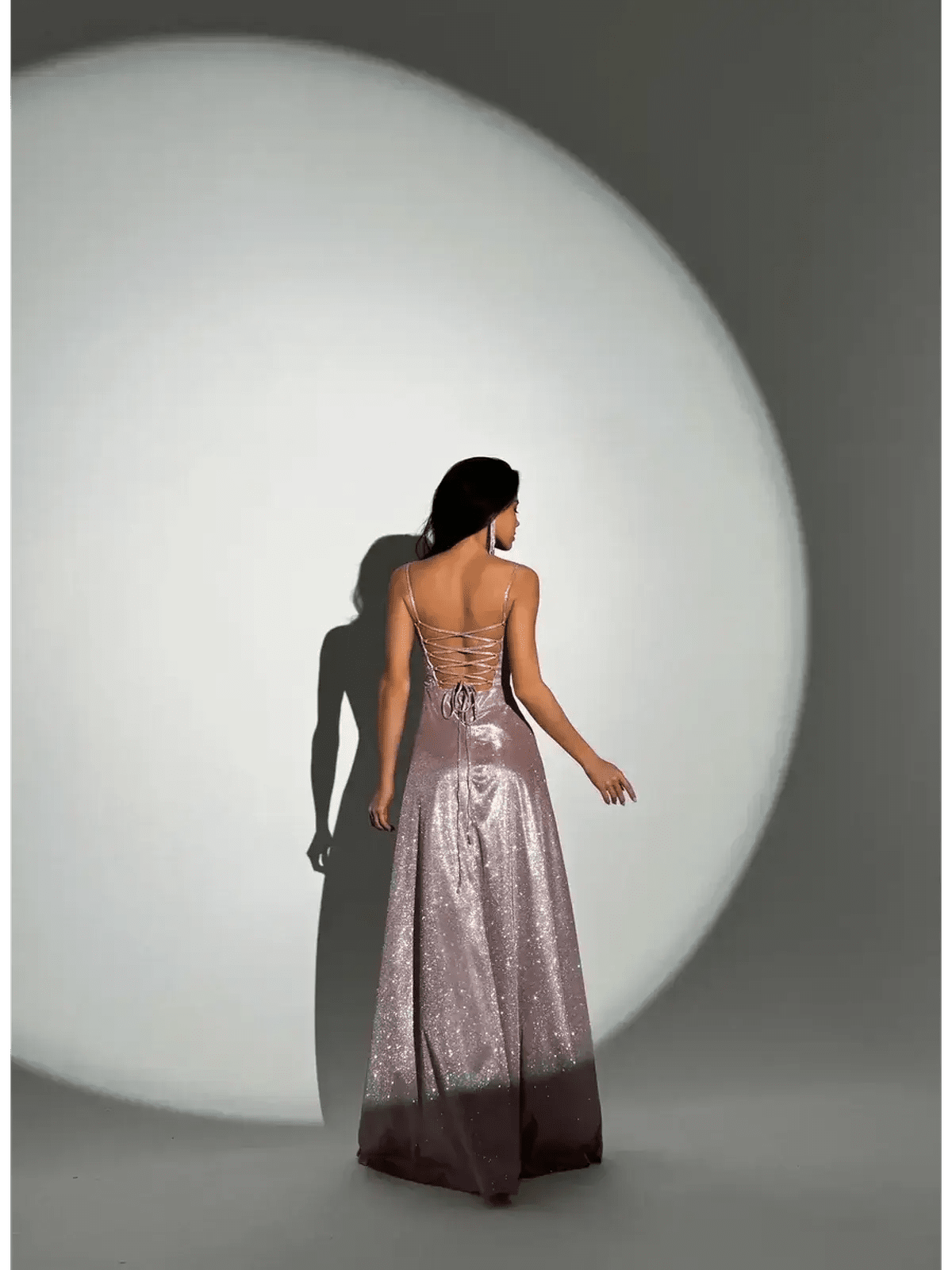 Elegant back view of the Lustrous Spell Maxi Dress in blush-pink, showcasing its sculpted bodice and flowing hemline.