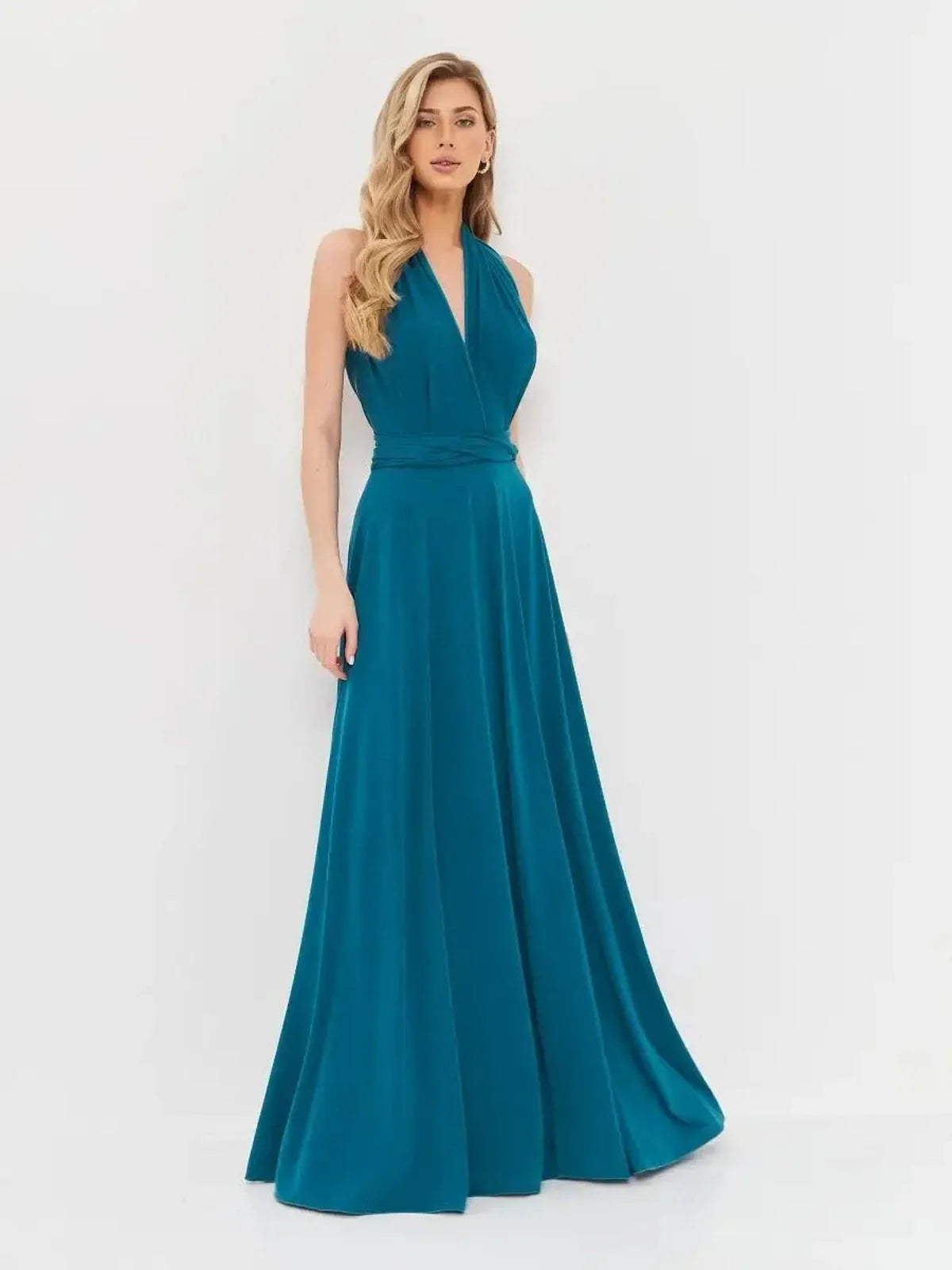 Elegant deep teal maxi dress with draped halter neck and flowing skirt, perfect for weddings and evening events.