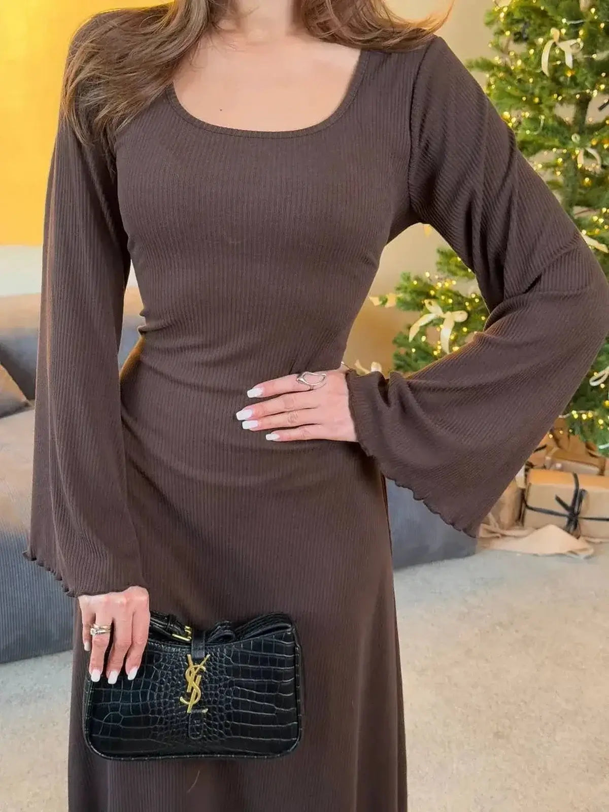 Mocha Ribbon long sleeve midi dress with ribbed texture and elegant bell sleeves, paired with a chic black handbag.