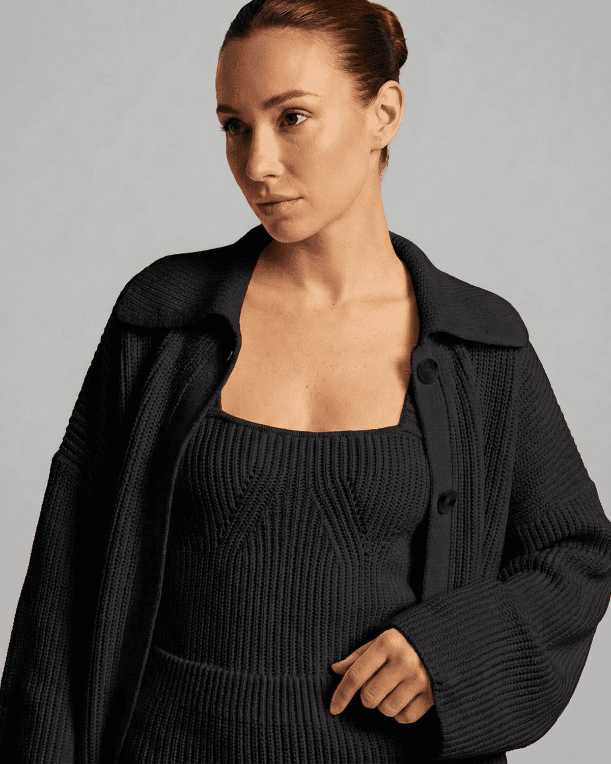 Onyx Mini Dress by Lauven, showcasing a woman in a fitted black knit outfit with a collared cardigan.