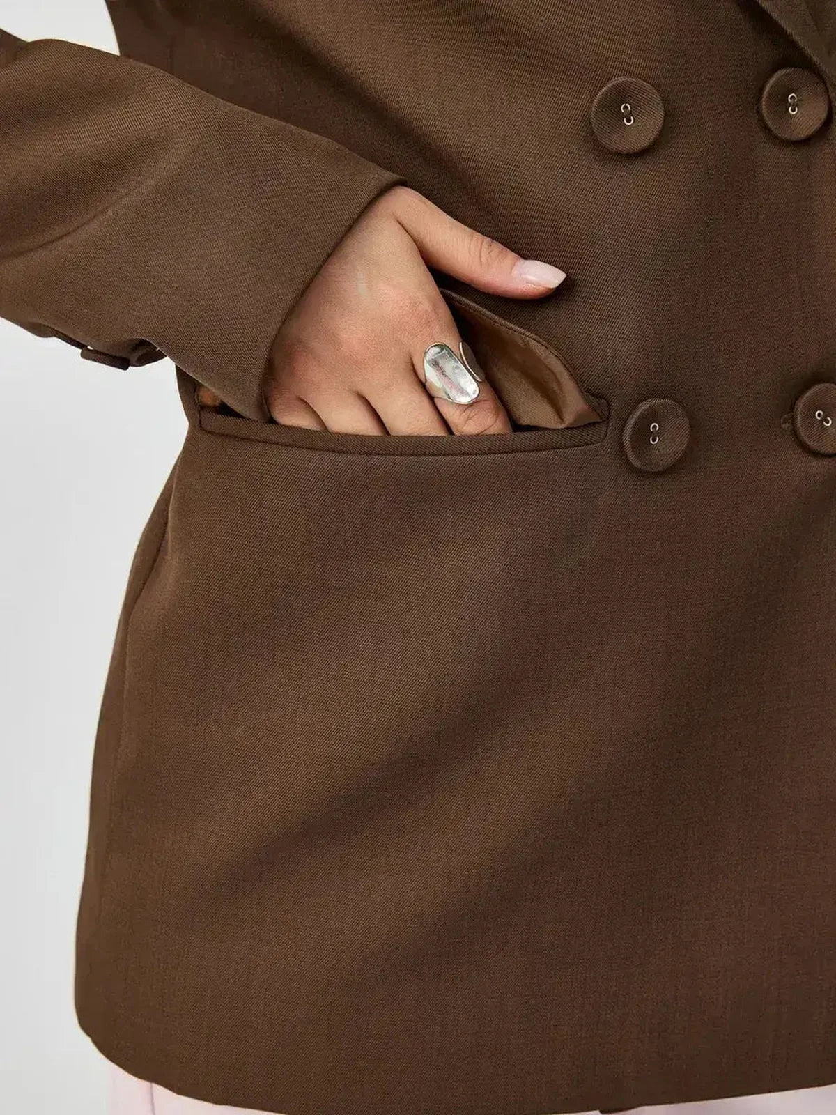 Close-up of the Saffron Blazer by Lauven, showcasing its oversized double-breasted design and stylish pocket.