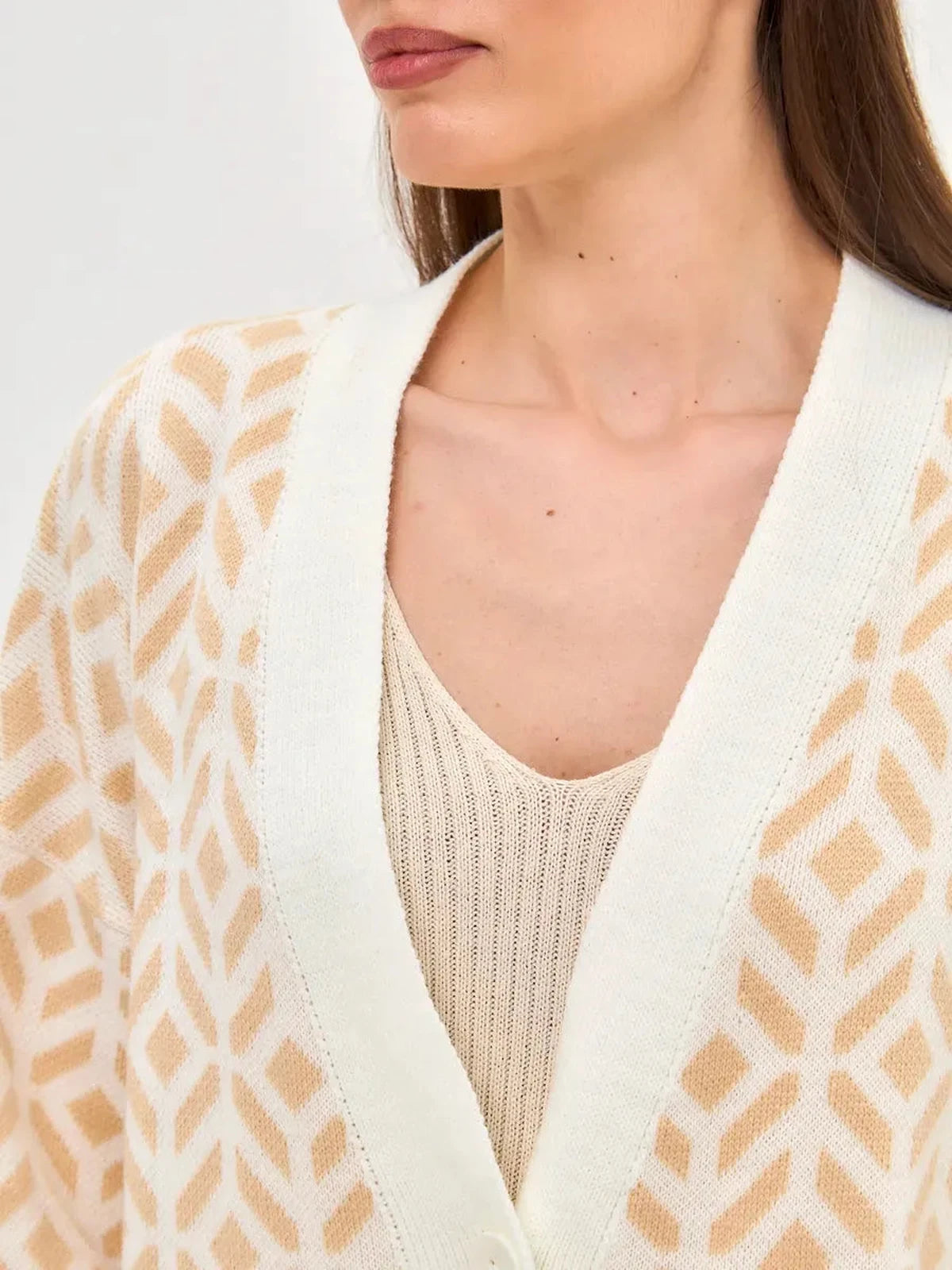 Sandy Cardigan by Lauven featuring a close-up view of its soft beige knit design and relaxed silhouette.