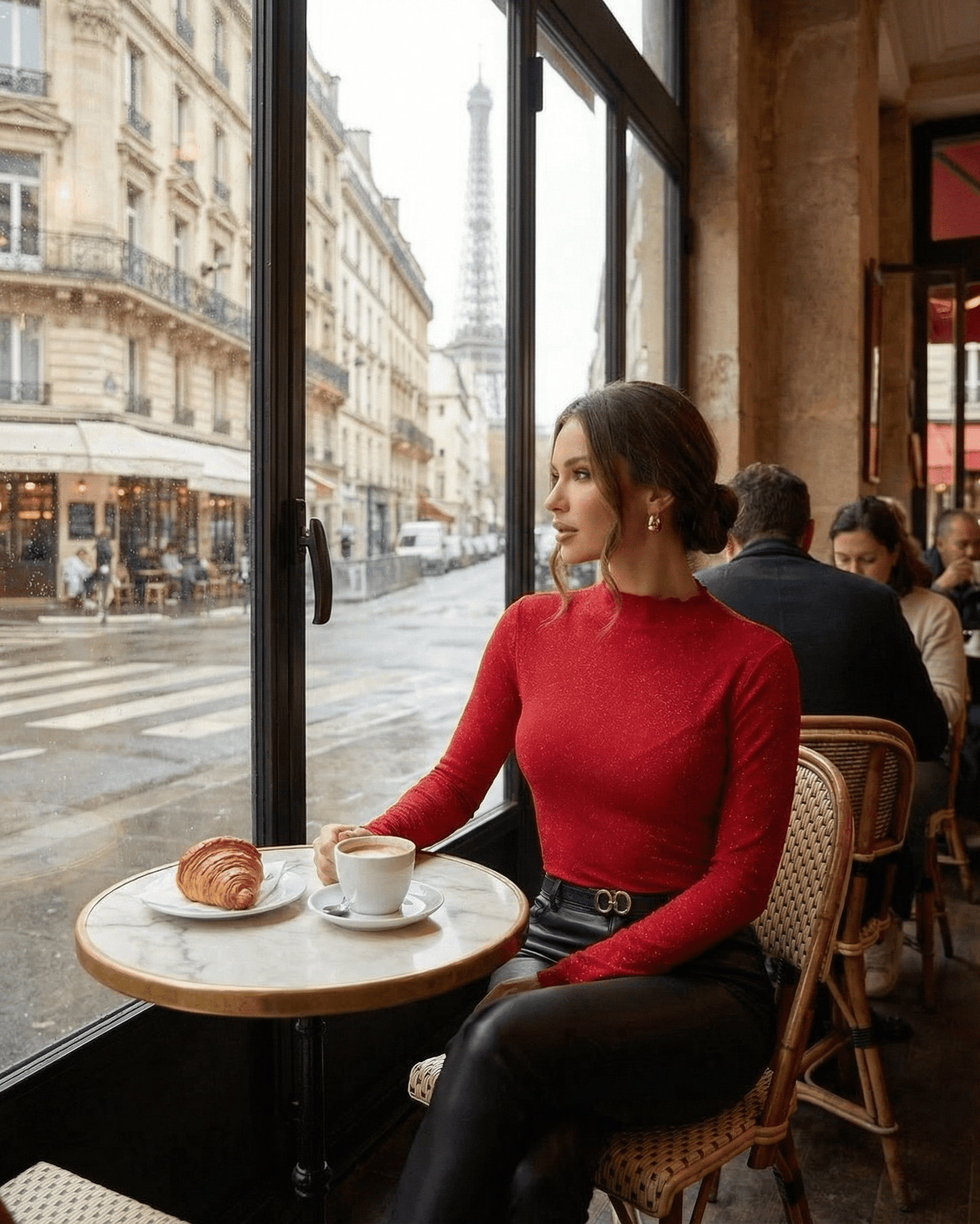 Scarlet Blouse by Lauven showcased in a café, featuring a long sleeve design and round neckline.
