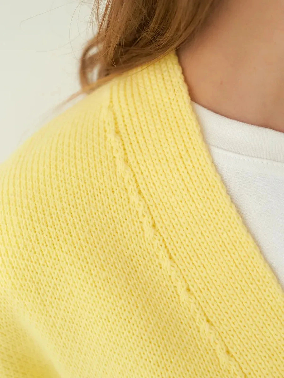 Sunny Cardigan by Lauven – Close-up of soft yellow knitwear texture and detail.