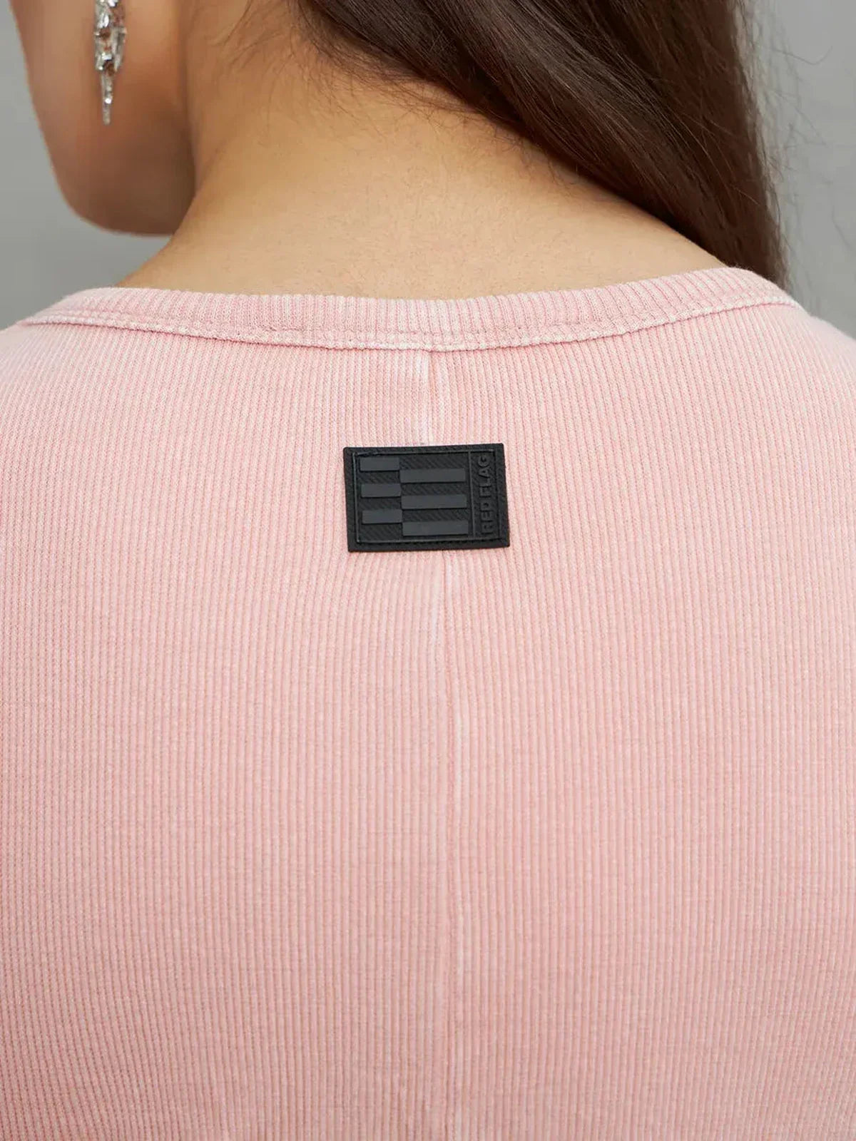 Close-up of the back neckline of the Rose Form Maxi Dress in dusty rose, featuring a sleek label and soft ribbed texture.