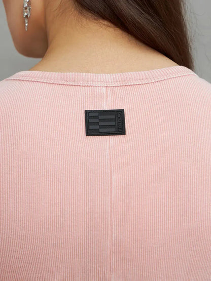 Close-up of the back neckline of the Rose Form Maxi Dress in dusty rose, featuring a sleek label and soft ribbed texture.