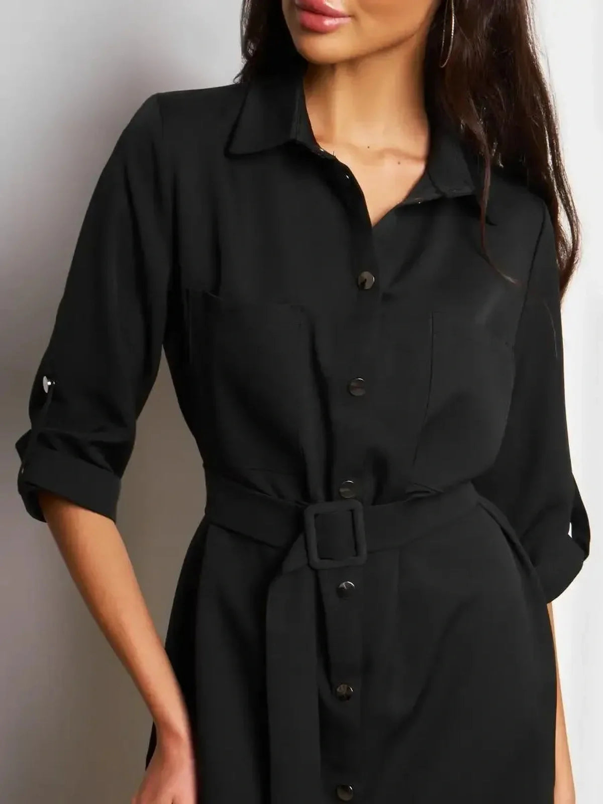 Model wearing the Urban Edit Mini black shirt-dress, featuring a structured silhouette and detachable belt for a cinched waist.