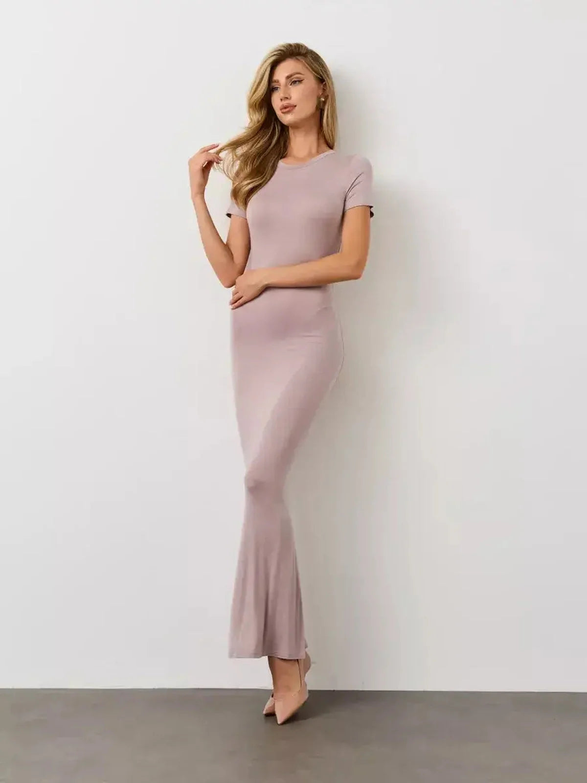 Bare Essence Maxi Dress in a neutral beige tone, featuring a smooth U-neckline and flared hem, perfect for stylish comfort.