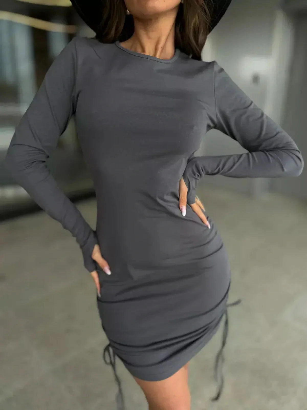 Graphite Rush long sleeve mini dress with ruched side ties, perfect for casual or formal occasions.