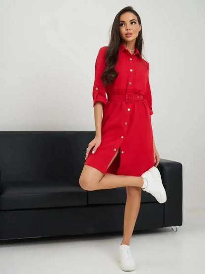 Model wearing a scarlet belted mini dress with a sleek silhouette, styled with white sneakers.