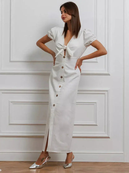 Maxi Dress Pearl Whisper featuring tie-front bodice, puff sleeves, and a button-down skirt, showcasing minimalist elegance.