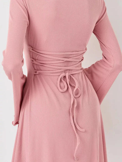 Back view of the Blush Whisper pink dress featuring a stylish lace-up design accentuating the waist.