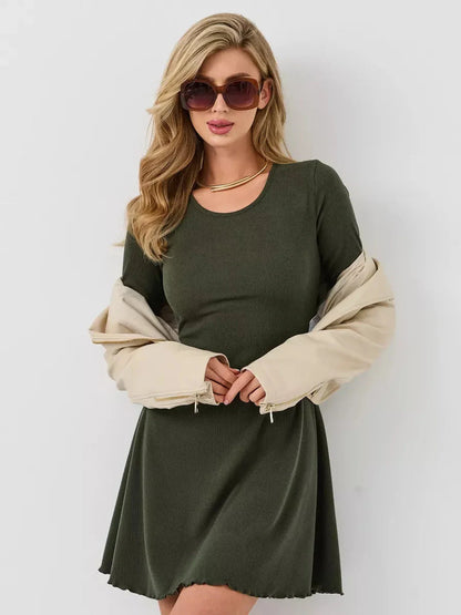 Model showcasing the Ivy Bell mini dress with flared sleeves, paired with sunglasses and a stylish jacket.