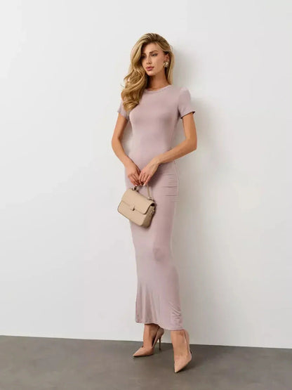 Bare Essence Maxi Dress in beige, showcasing a smooth silhouette, short sleeves, and elegant flared hem for all-day comfort.