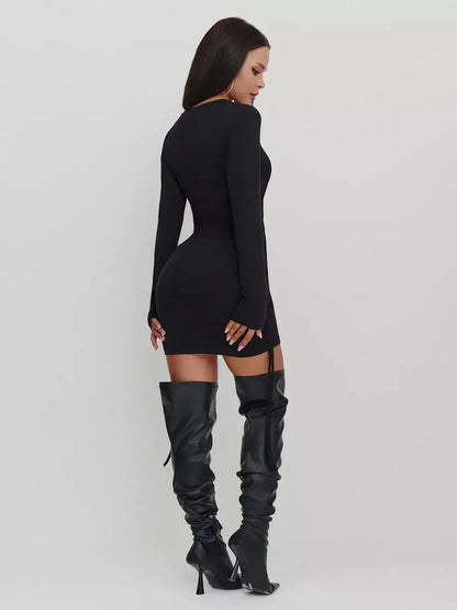 Back view of a black long sleeve midi dress, tailored for a flattering silhouette and styled with knee-high boots.