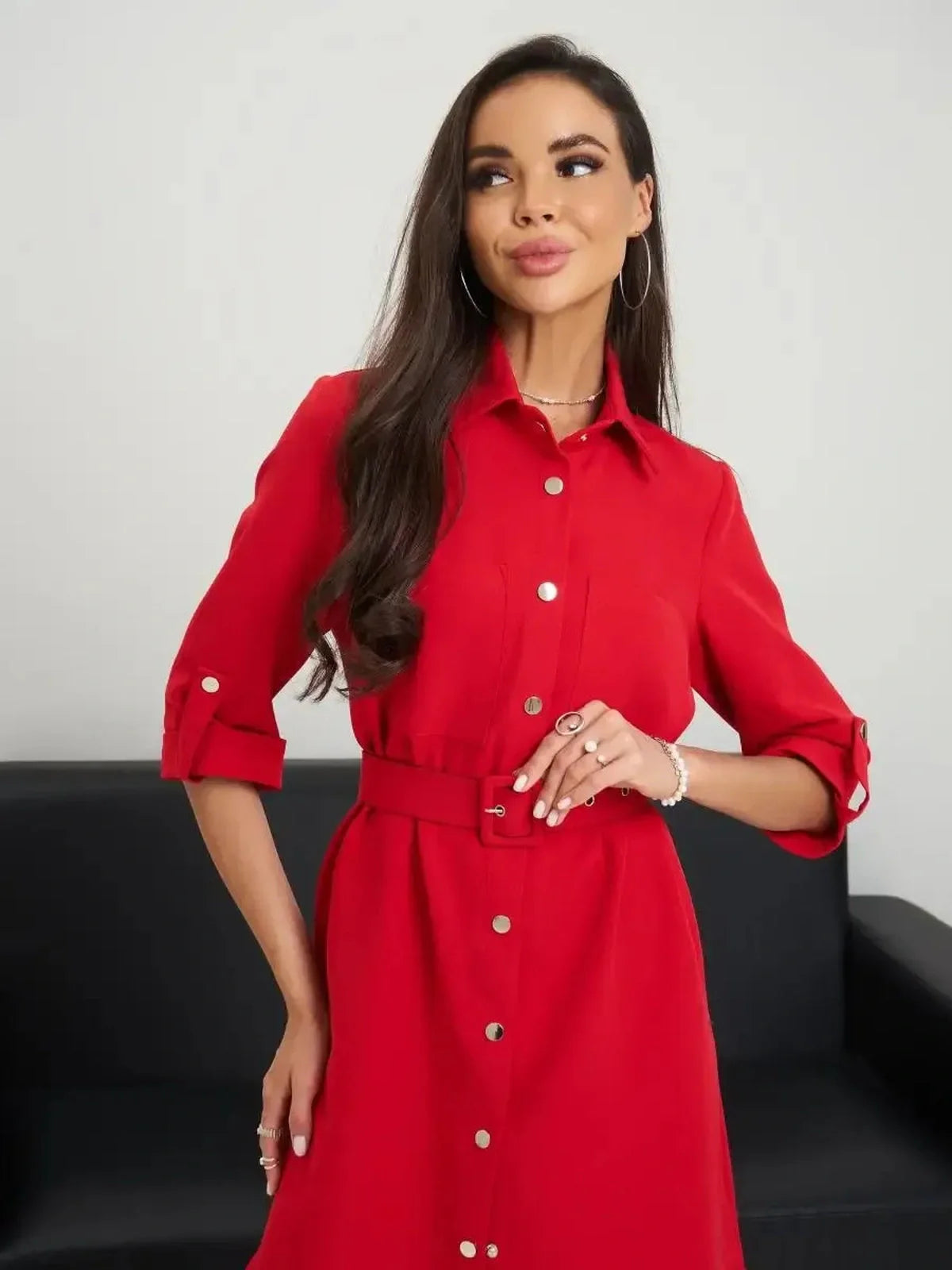 Model wearing a scarlet belted mini dress showcasing a sculpted fit and classic shirt-dress style.