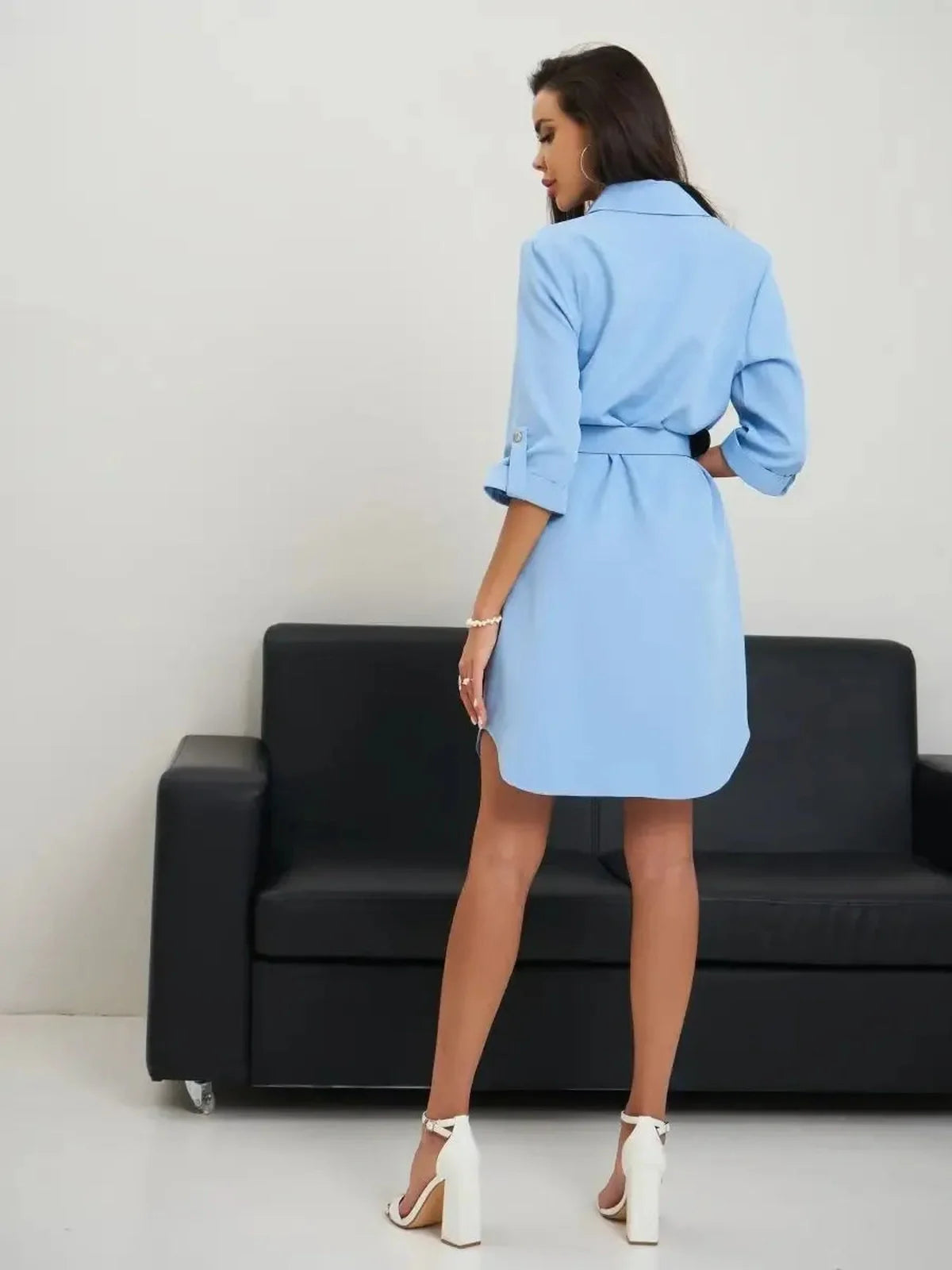 Back view of a chic sky-blue Skyline Mini Dress with rolled sleeves and adjustable belt, elegantly styled on a model.