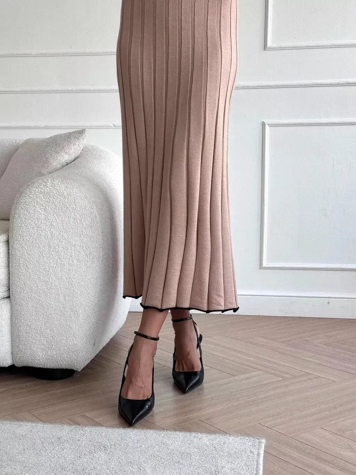 Close-up of Sahara Curve Maxi Dress in sandstone beige, showcasing soft ribbed texture and elegant full-length design.
